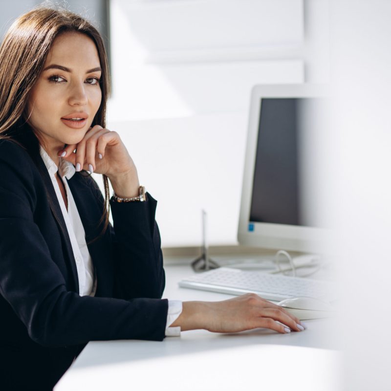 Business woman working on a computer in an office